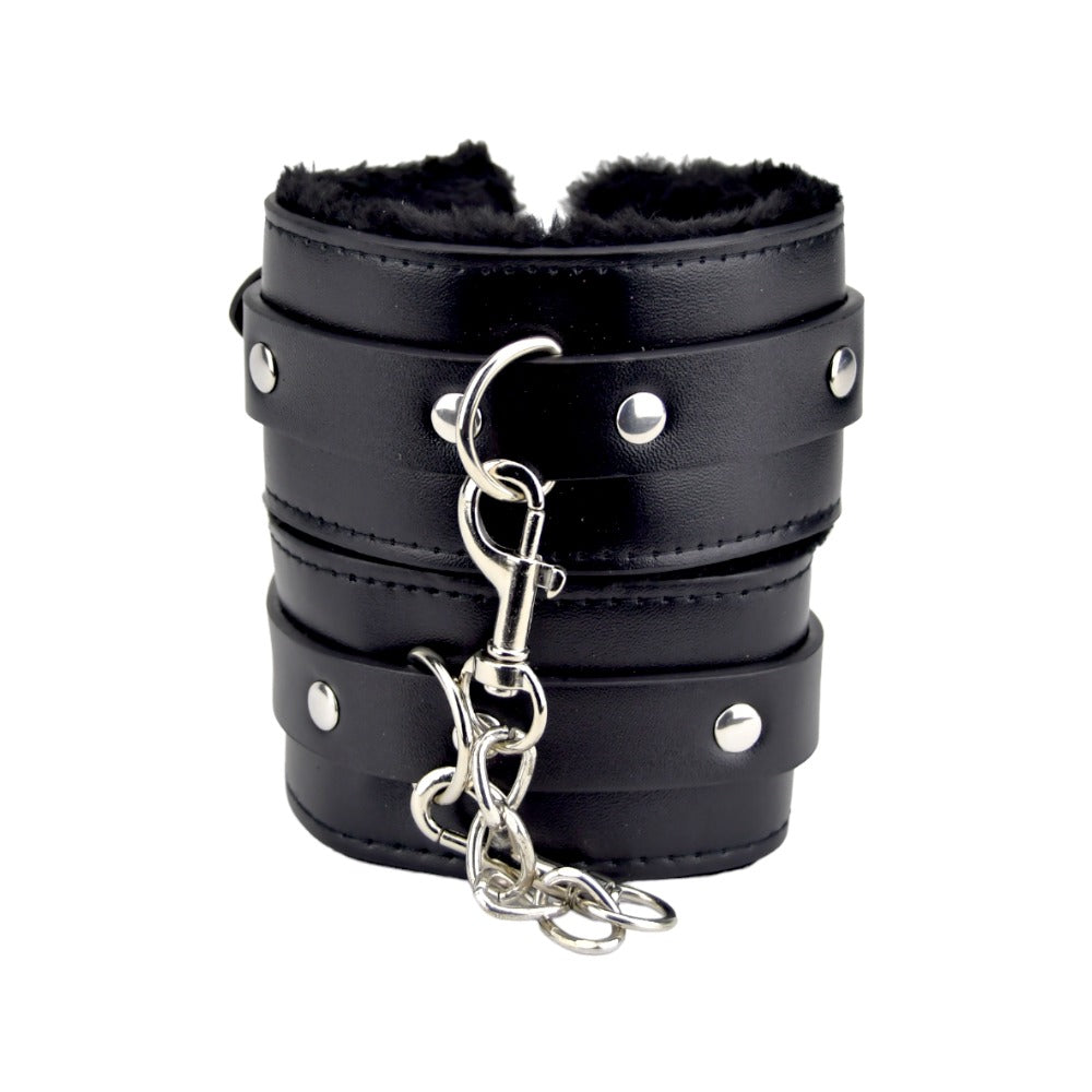 Black furry plush wrist cuffs from Bound to Please bondage restraints set, featuring soft material and adjustable straps.