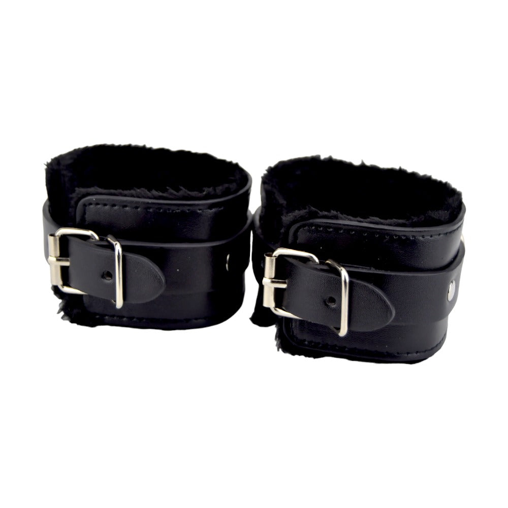 Black furry plush wrist cuffs from Bound to Please, designed as bondage restraints with soft, comfortable material for adult use.