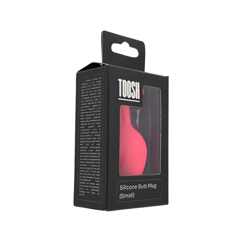 Small pink silicone butt plug by Toosh, featuring a smooth texture and tapered design for comfortable use.