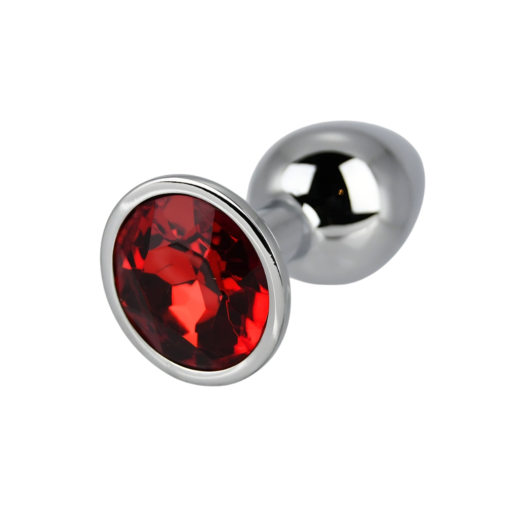 Small silver metal butt plug with red stone detail by Toosh, designed for intimate pleasure and discreet use.